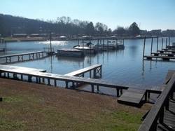 A lakeside marina with wooden docks and boats.