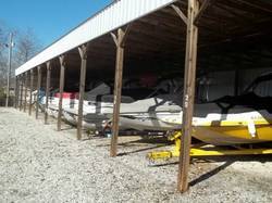 Covered dry storage with multiple boats parked.